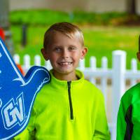Two boys smiling with Laker Up foam fingers